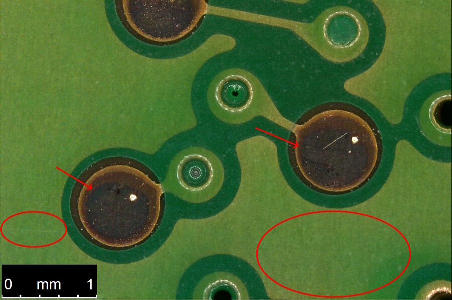  Image of a portion of the PCB underside of a hard drive taken with the DVM6 using the integrated LED ring light and diffusor. Compare areas encircled and denoted by arrows with Fig. 4b showing an image of the same area taken with coaxial illumination.