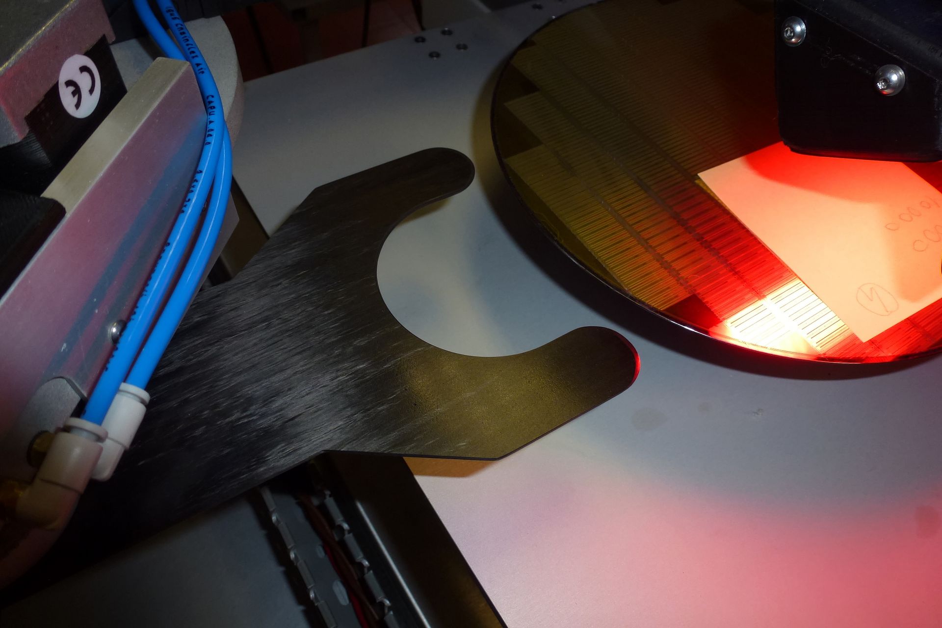 Automated wafer loader using carbon fiber end-effectors for safer handling.