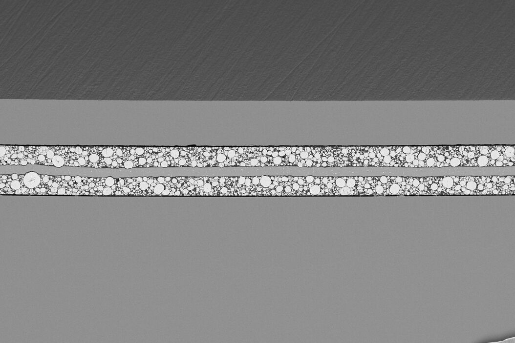SEM image of the full Li-NMC electrode sample, showing the two porous layers and the metal film at the center of the structure.